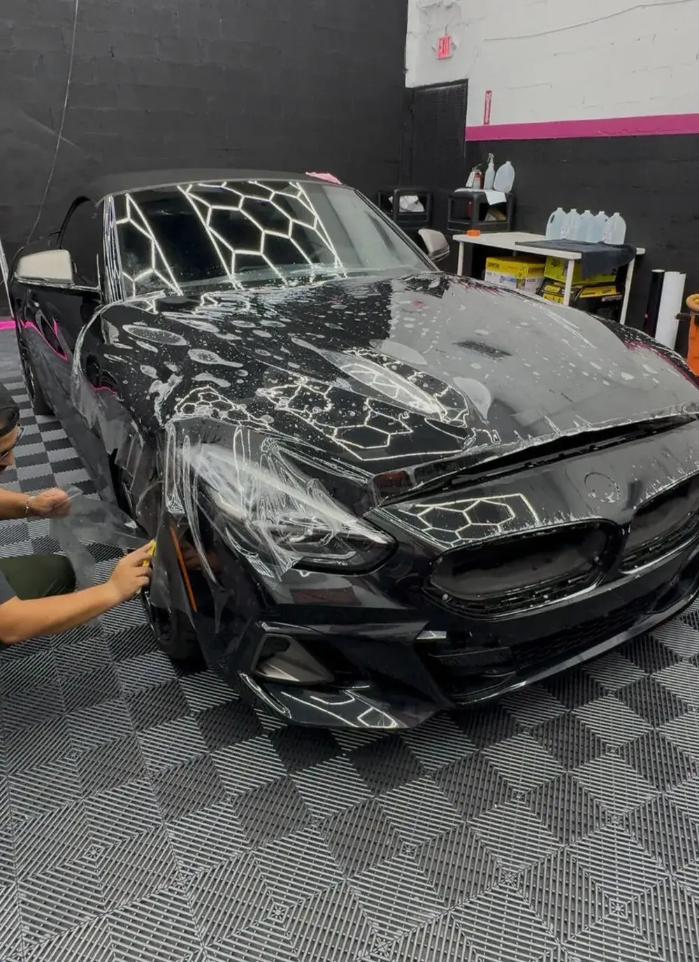 Full-body paint protection film installed on a black luxury car at Tasha Car Detailing Miami