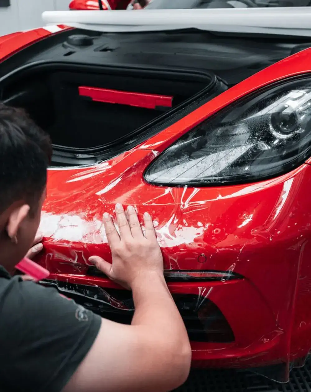Full-front PPF clear bra applied to a red sports car