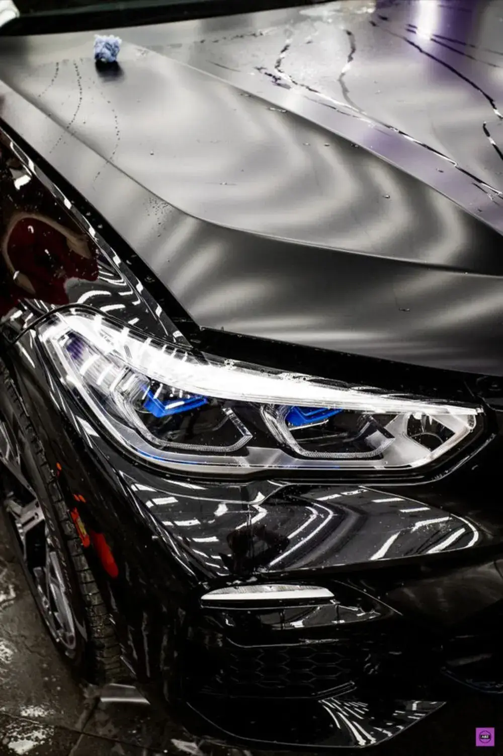 Clear bra paint protection film on a black BMW front end