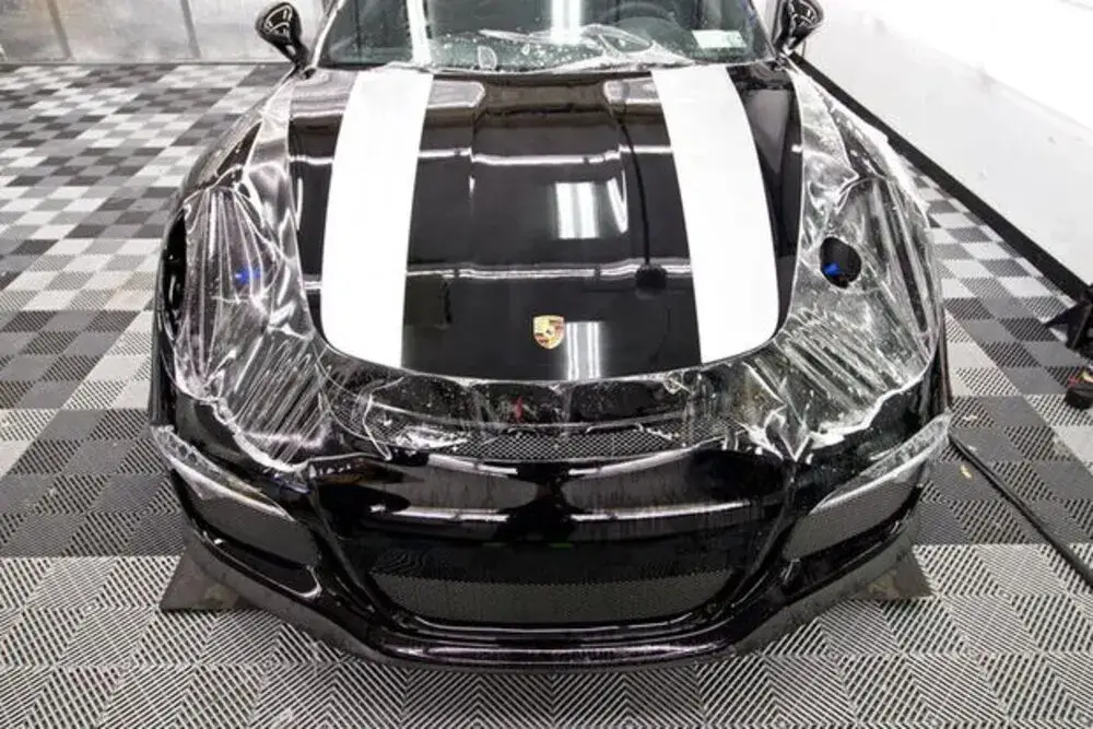 Track package paint protection film on a striped sports car in Miami